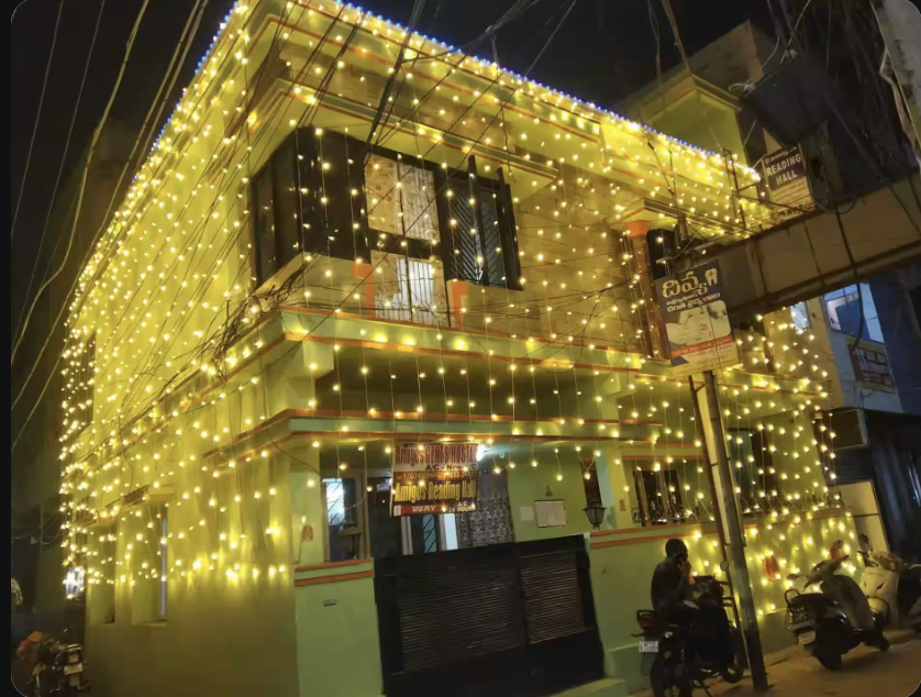 Hostel building exterior in the evening at Amigos Gents Hostel, Labbipet, Vijayawada